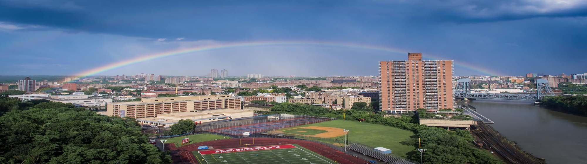 Bronx skyline with rainbow over athletic fields